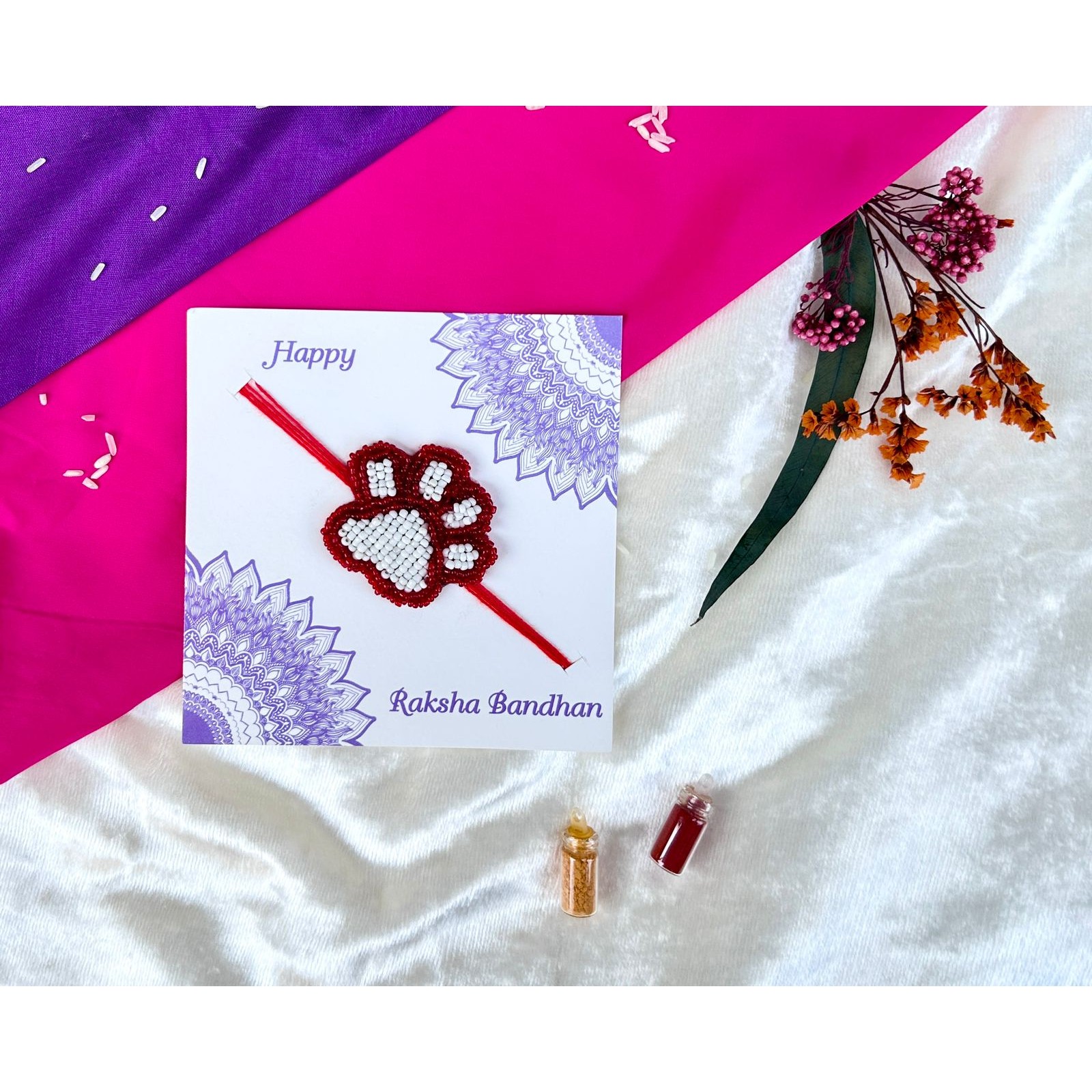White and red beaded paw Rakhi