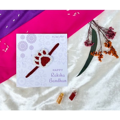 Red and white beaded paw Rakhi — handmade in India by Paws & Feet