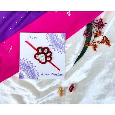 White and red beaded paw Rakhi — handmade in India by Paws & Feet